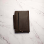 Brown leather portfolio organizer on a marble surface