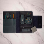 Travel organizer case open displaying storage compartments on a marble surface.