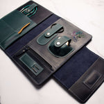 luxury leather travel wallet with multiple compartments for organizing cards, pens, and accessories on a marble surface